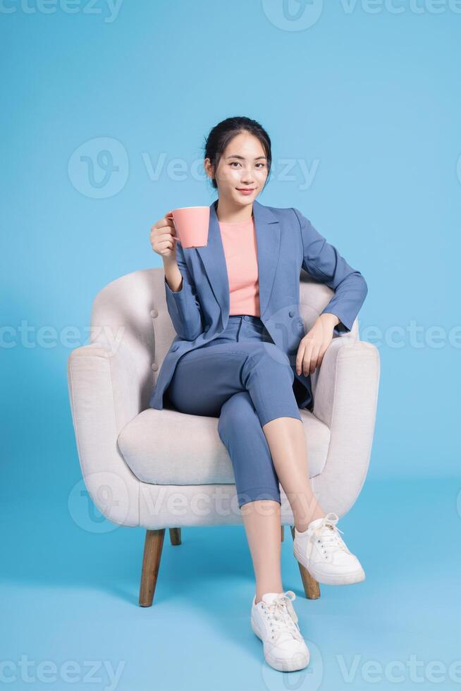 Photo of young Asian businesswoman on background