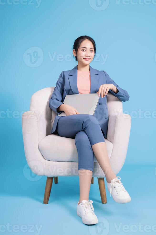 Photo of young Asian businesswoman on background