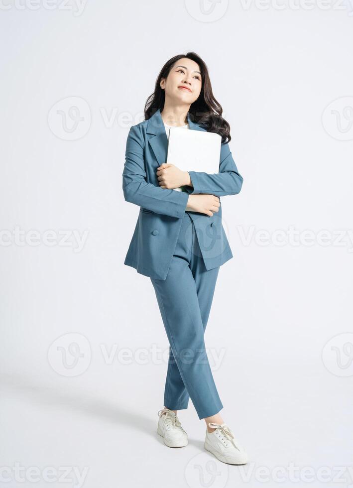 Image of young Asian business woman on background photo