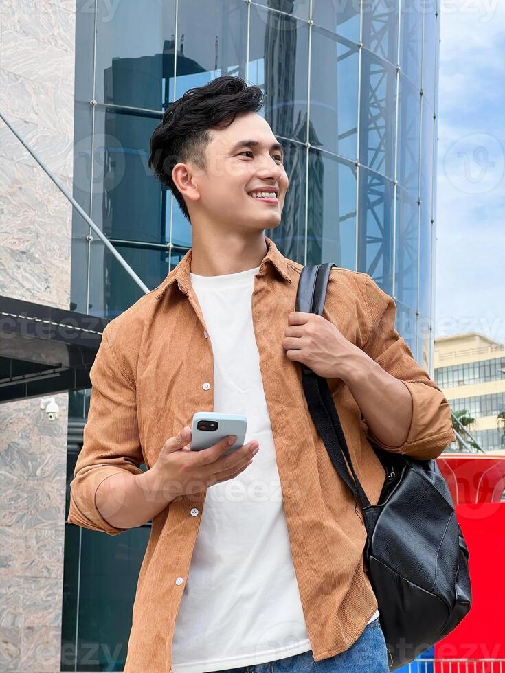 Portrait of young Asian man outside photo