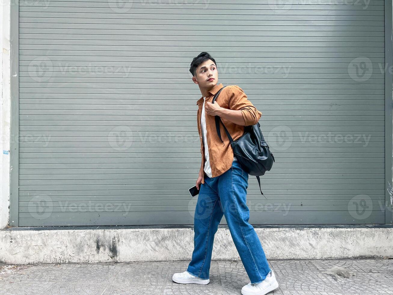 Portrait of young Asian man outside photo