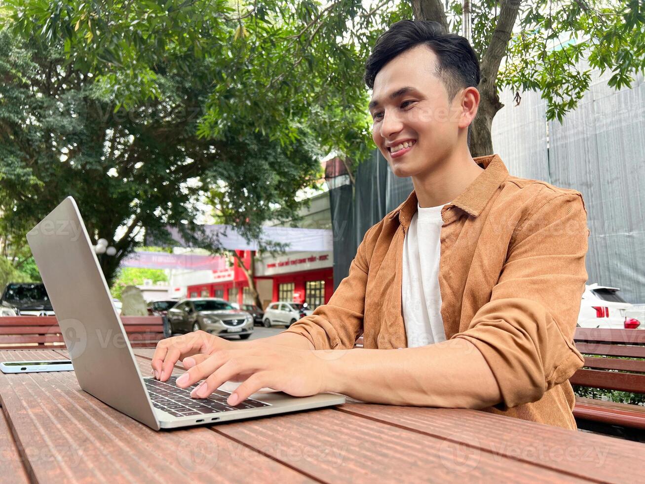 Portrait of young Asian man outside photo