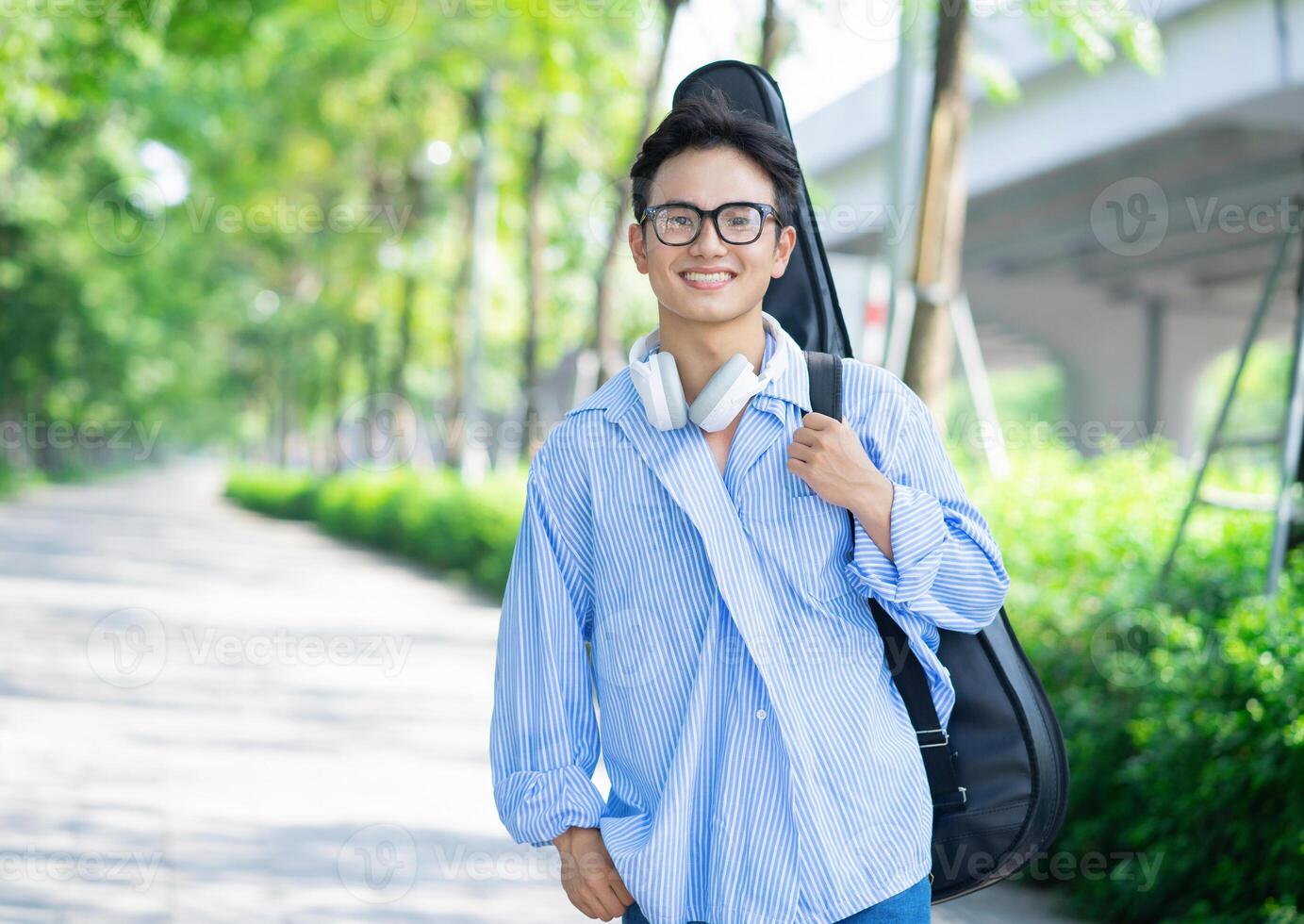 Portrait of young Asian man outside photo