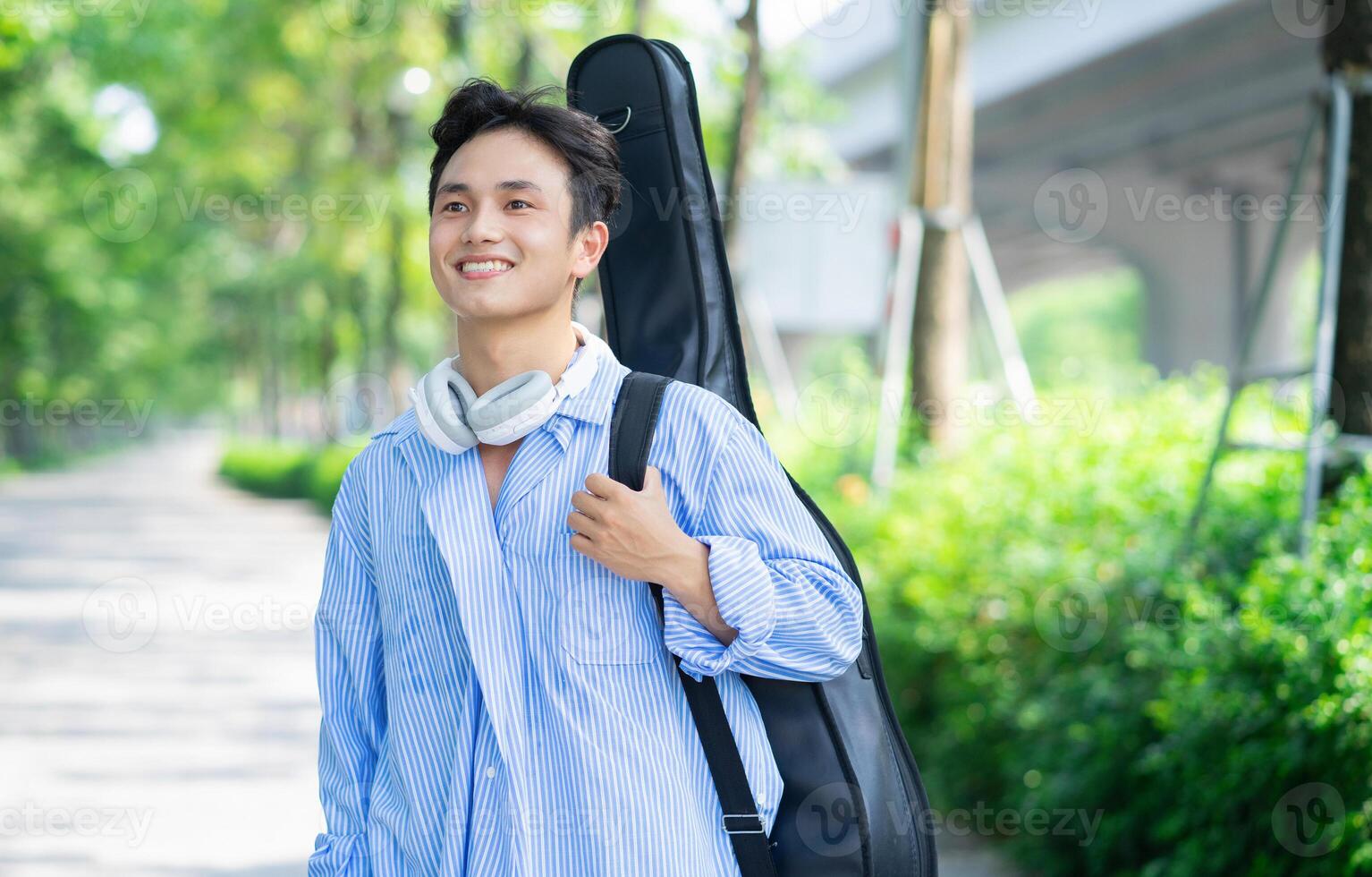 Portrait of young Asian man outside photo