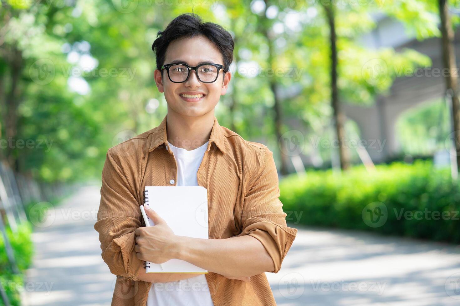 Portrait of young Asian man outside photo