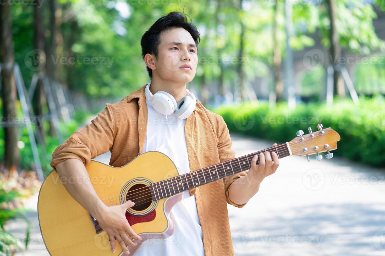 Portrait of young Asian man outside photo