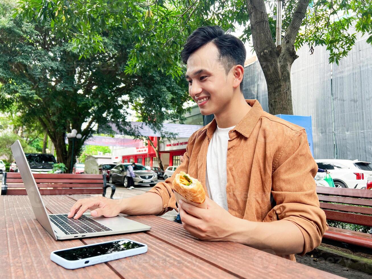 Portrait of young Asian man outside photo