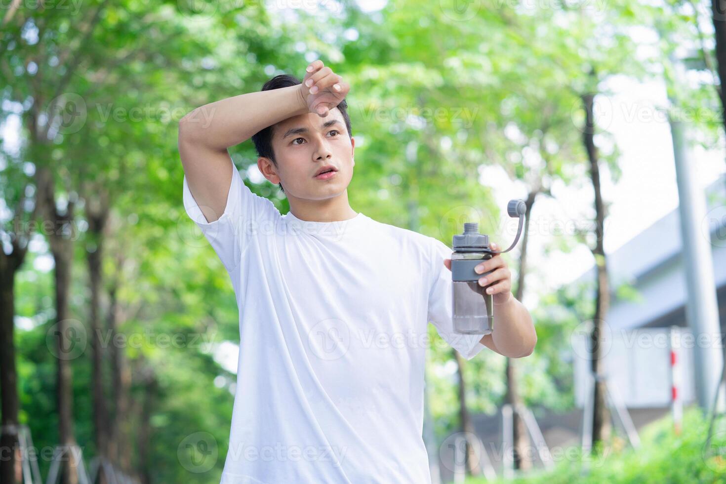 Portrait of young Asian man outside photo