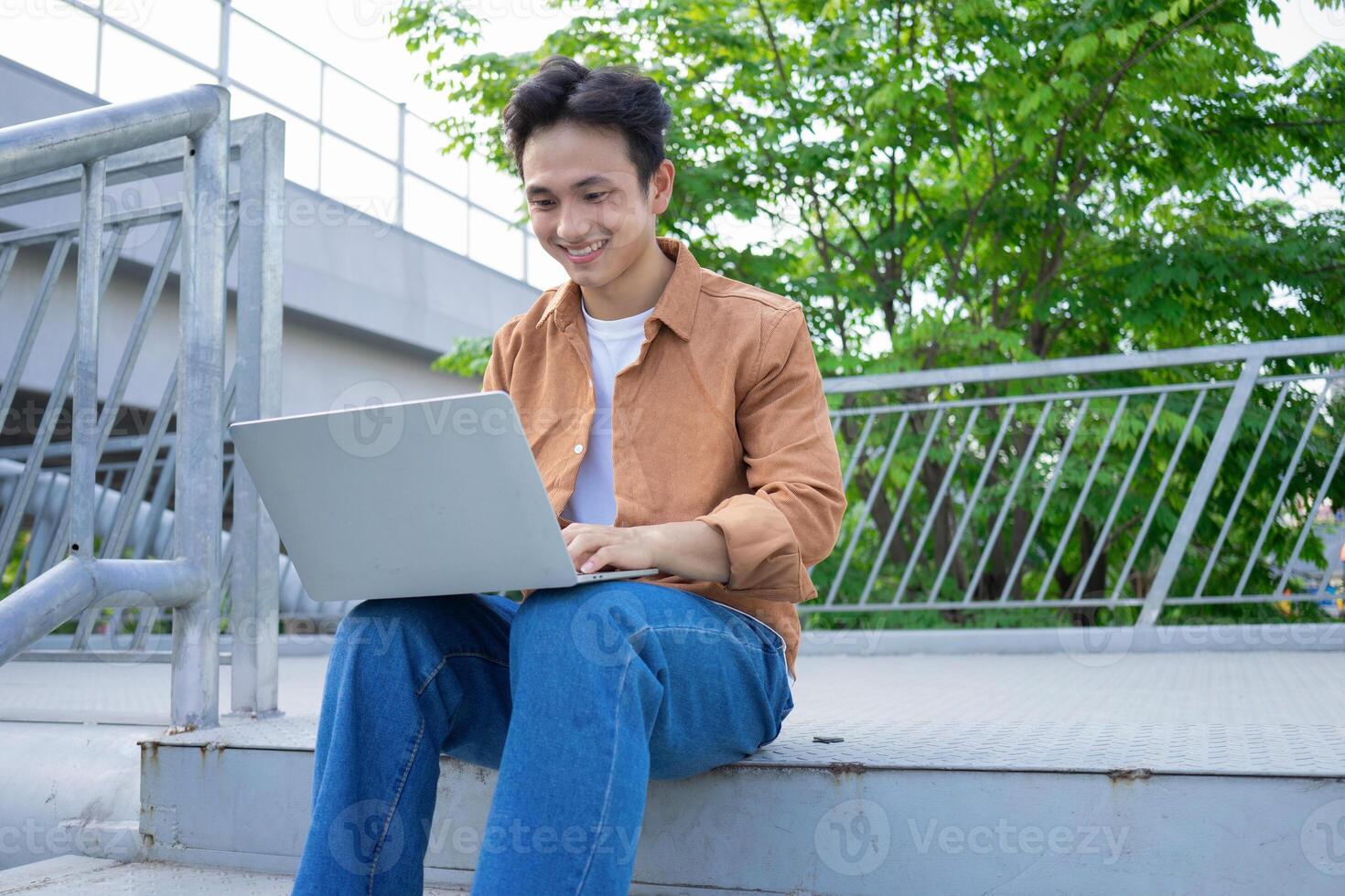 Portrait of young Asian man outside photo