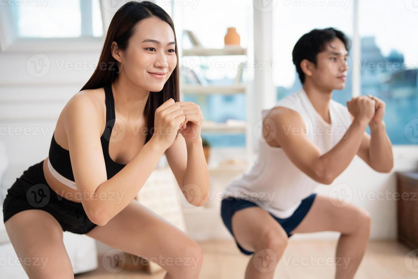 Photo of young Asian couple at home