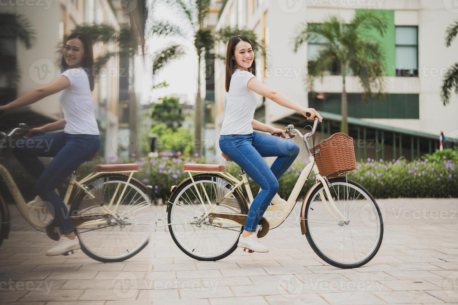 Photo of young Asian woman with bicycle