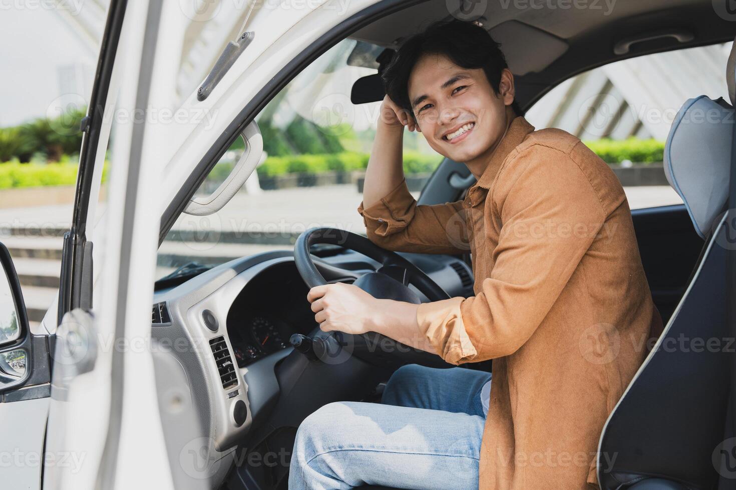 Photo of young Asian man with his truck