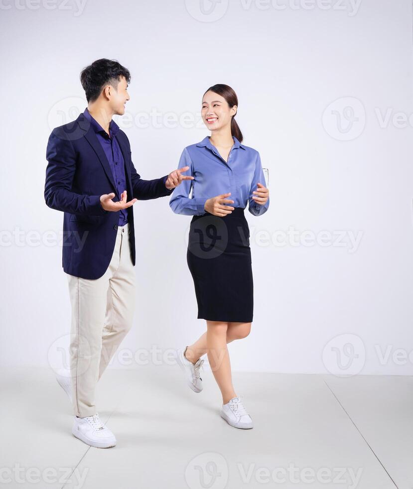 Photo of two young Asian business people on white background