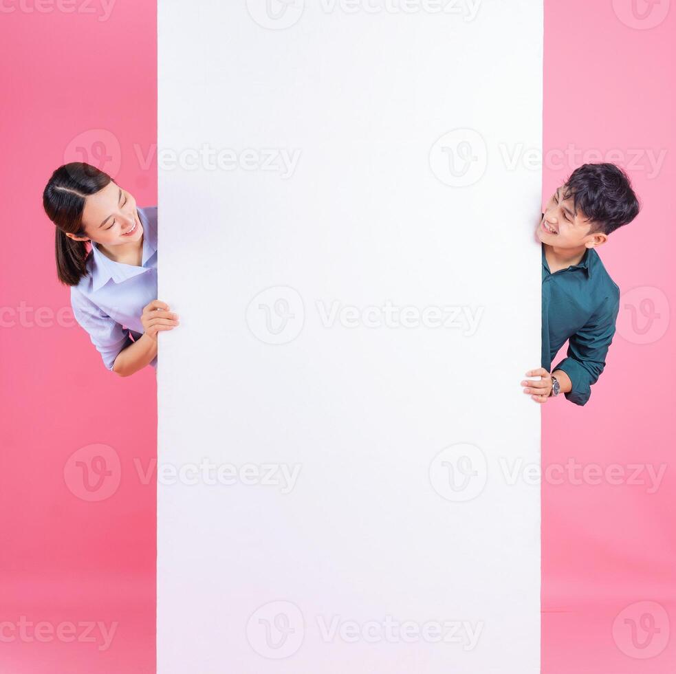 Photo of young Asian couple on background