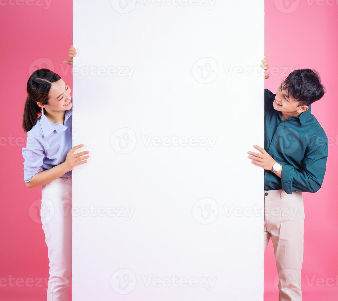 Photo of young Asian couple on background