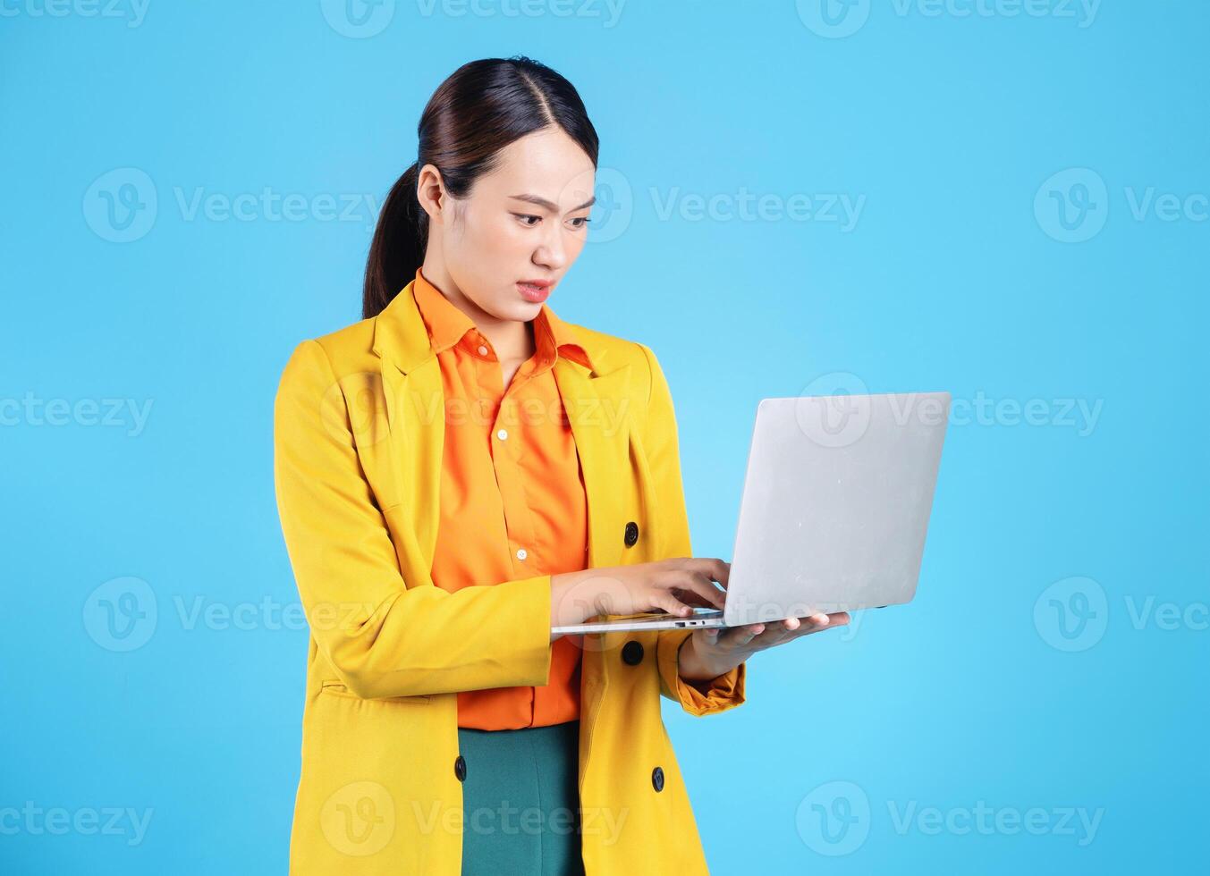 Photo of young Asian businesswoman with colorful suit on background