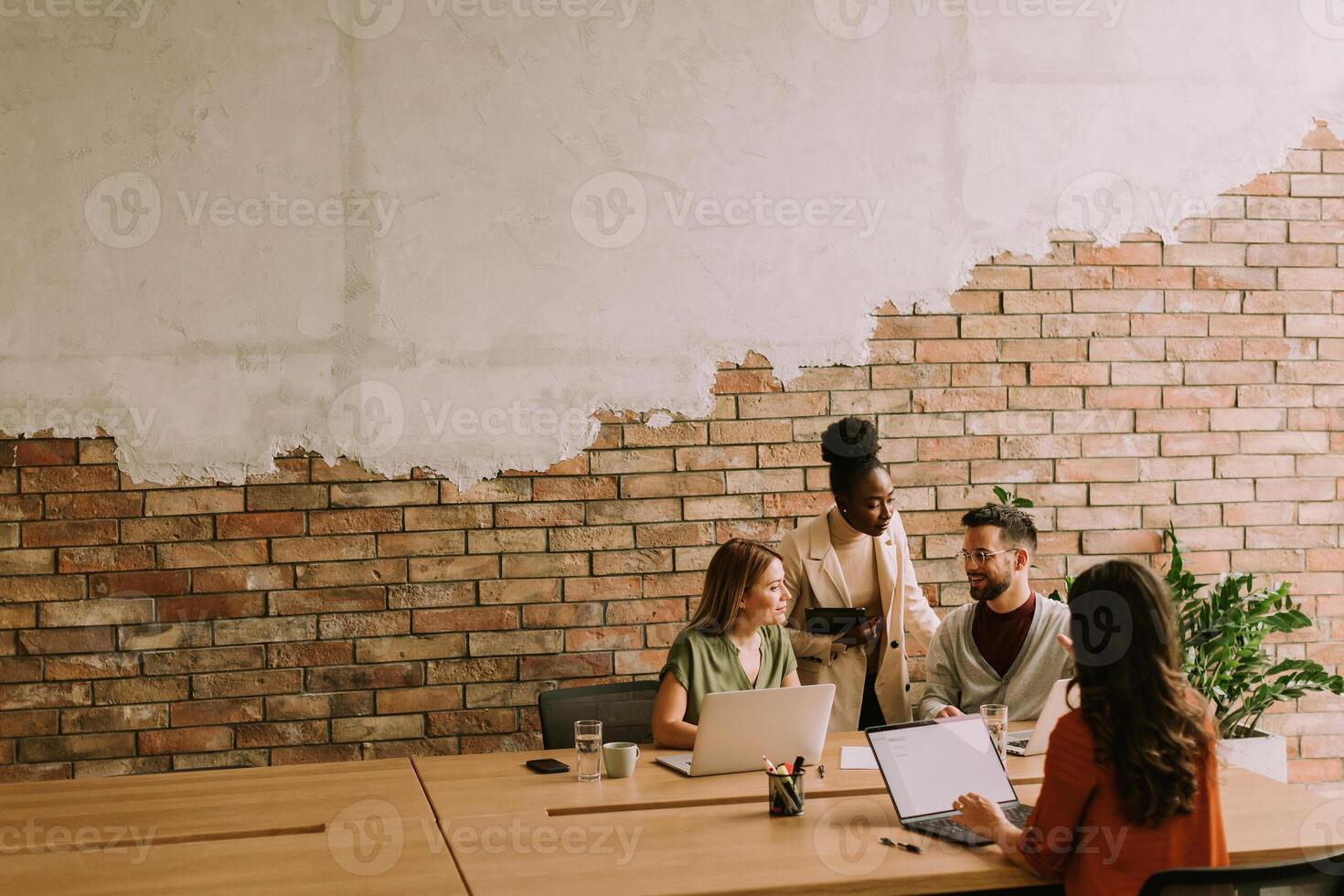 Young multiethnic startup team working in the rustic office photo