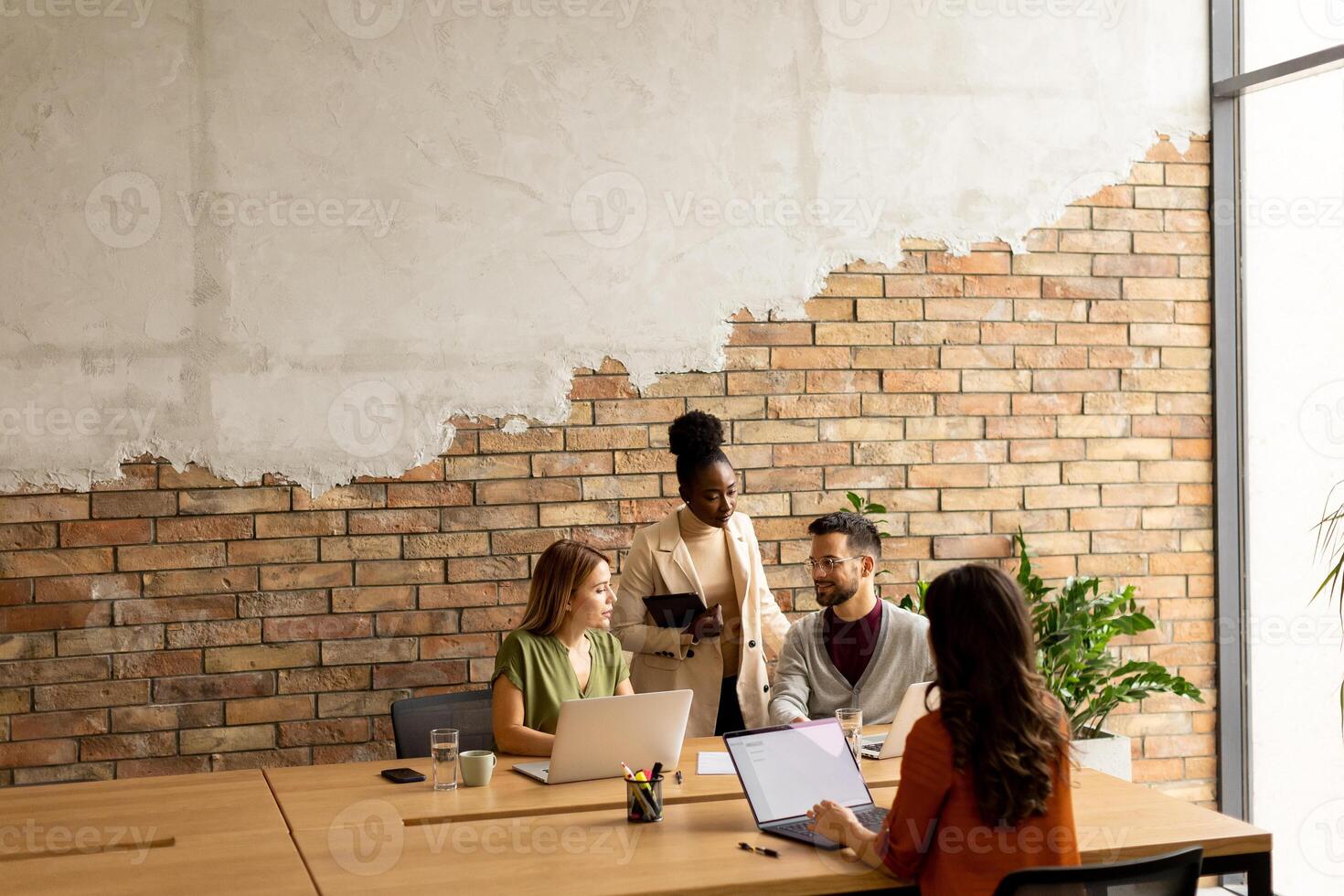 Young multiethnic startup team working in the rustic office photo