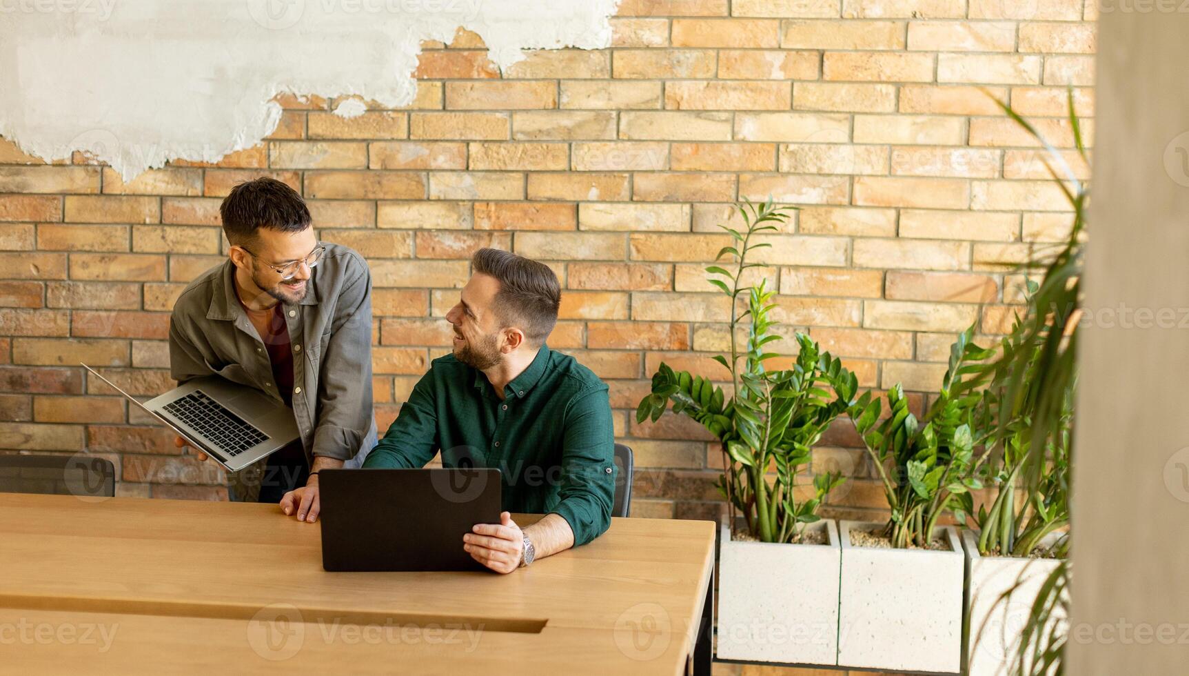 Collaboration in Motion, Professionals Working Together in a Modern Brick-Walled Office photo
