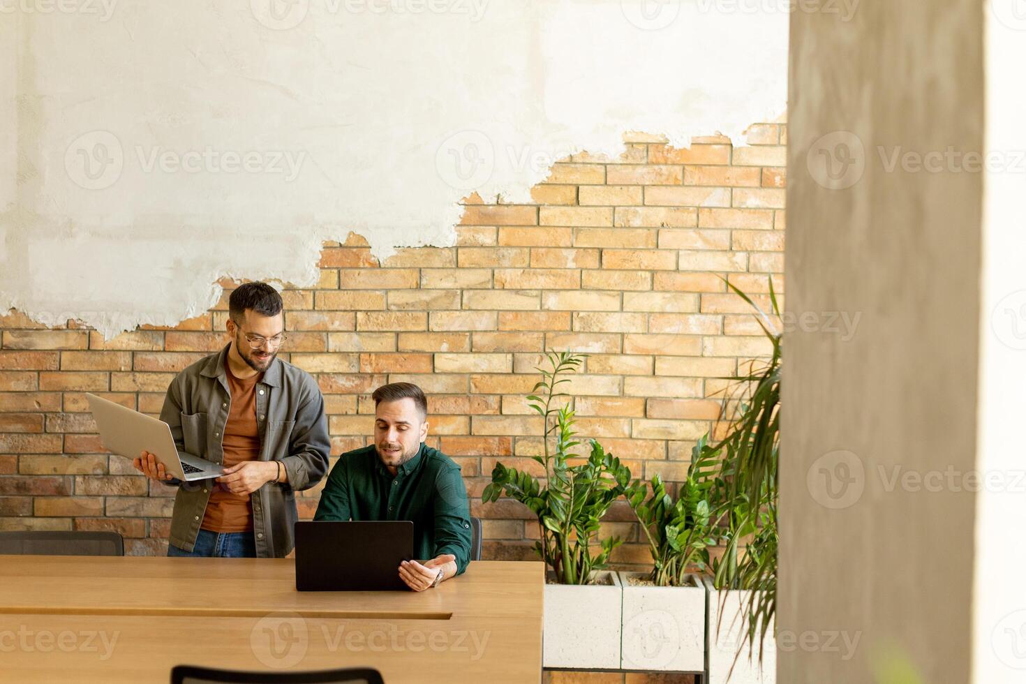 Collaboration in Motion, Professionals Working Together in a Modern Brick-Walled Office photo