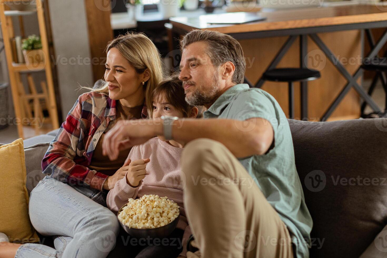Family Movie Night, Engrossed in Thrilling Scenes at Home photo