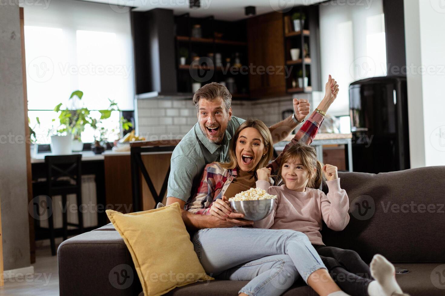 Family Movie Night Engrossed in Thrilling Scenes at Home photo