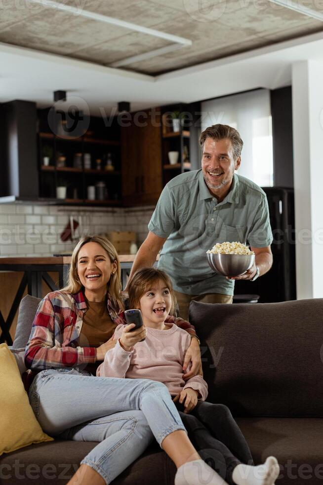 Family Movie Night, Engrossed in Thrilling Scenes at Home photo