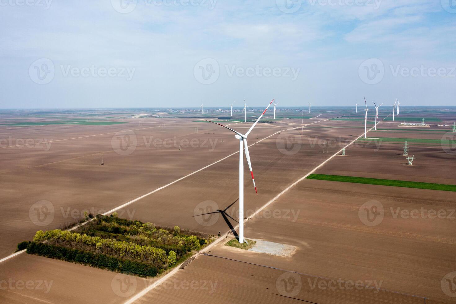 Vast Wind Farm Stretching Across Fertile Plains at the Break of Dawn photo
