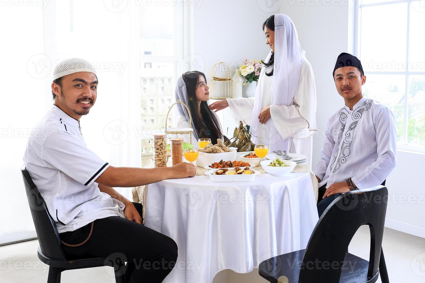 Women and Man Sitting to Celebrate Eid al Fitr photo