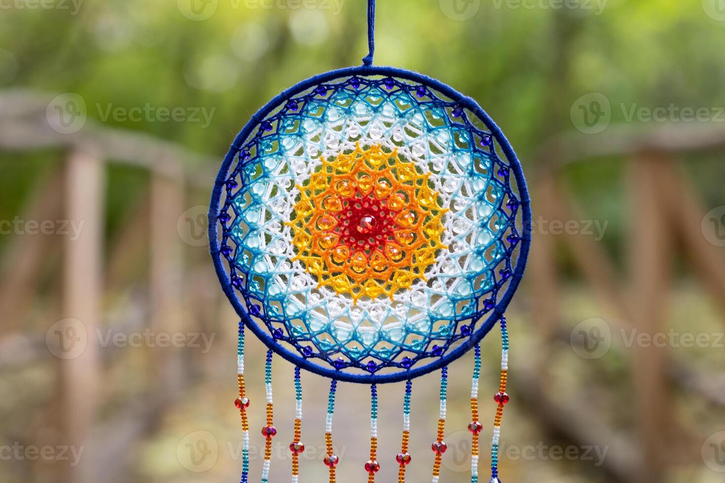 Handmade dream catcher with feathers threads and beads rope hanging photo
