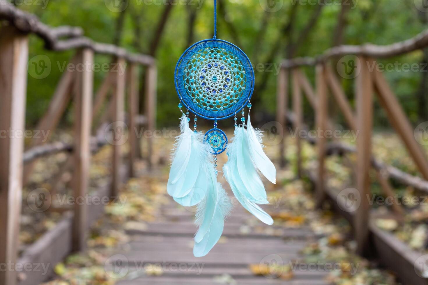 Handmade dream catcher with feathers threads and beads rope hanging photo