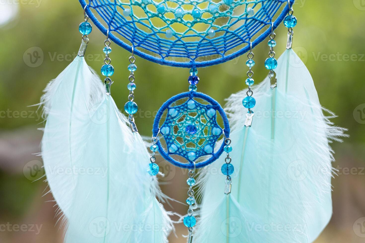 Handmade dream catcher with feathers threads and beads rope hanging photo