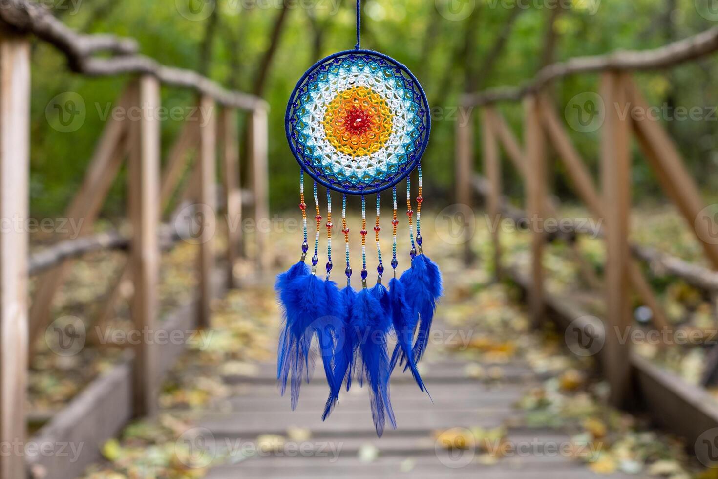 Handmade dream catcher with feathers threads and beads rope hanging photo