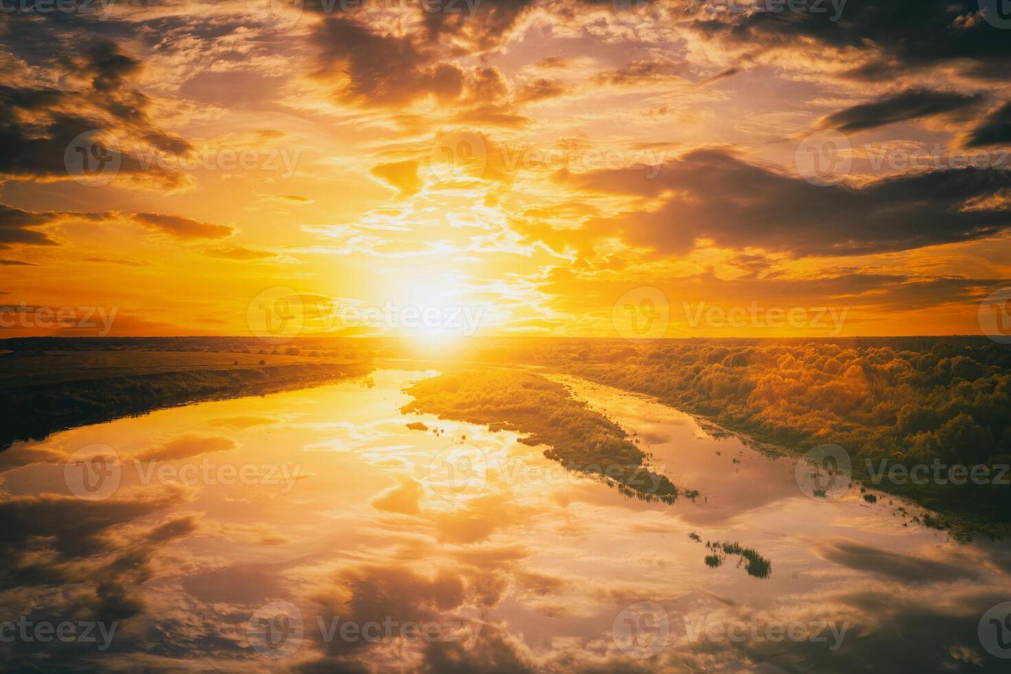 Sunrise or sunset on a lake or river with cloudy sky reflection in the water in summertime. Aesthetics of vintage film. photo