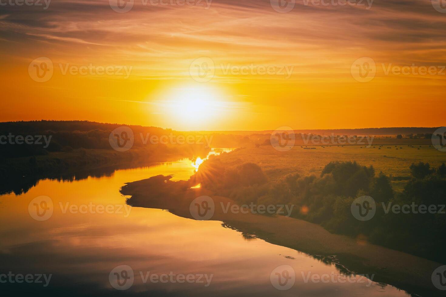 Sunrise or sunset on a lake or river with cloudy sky reflection in the water in summertime. Aesthetics of vintage film. photo
