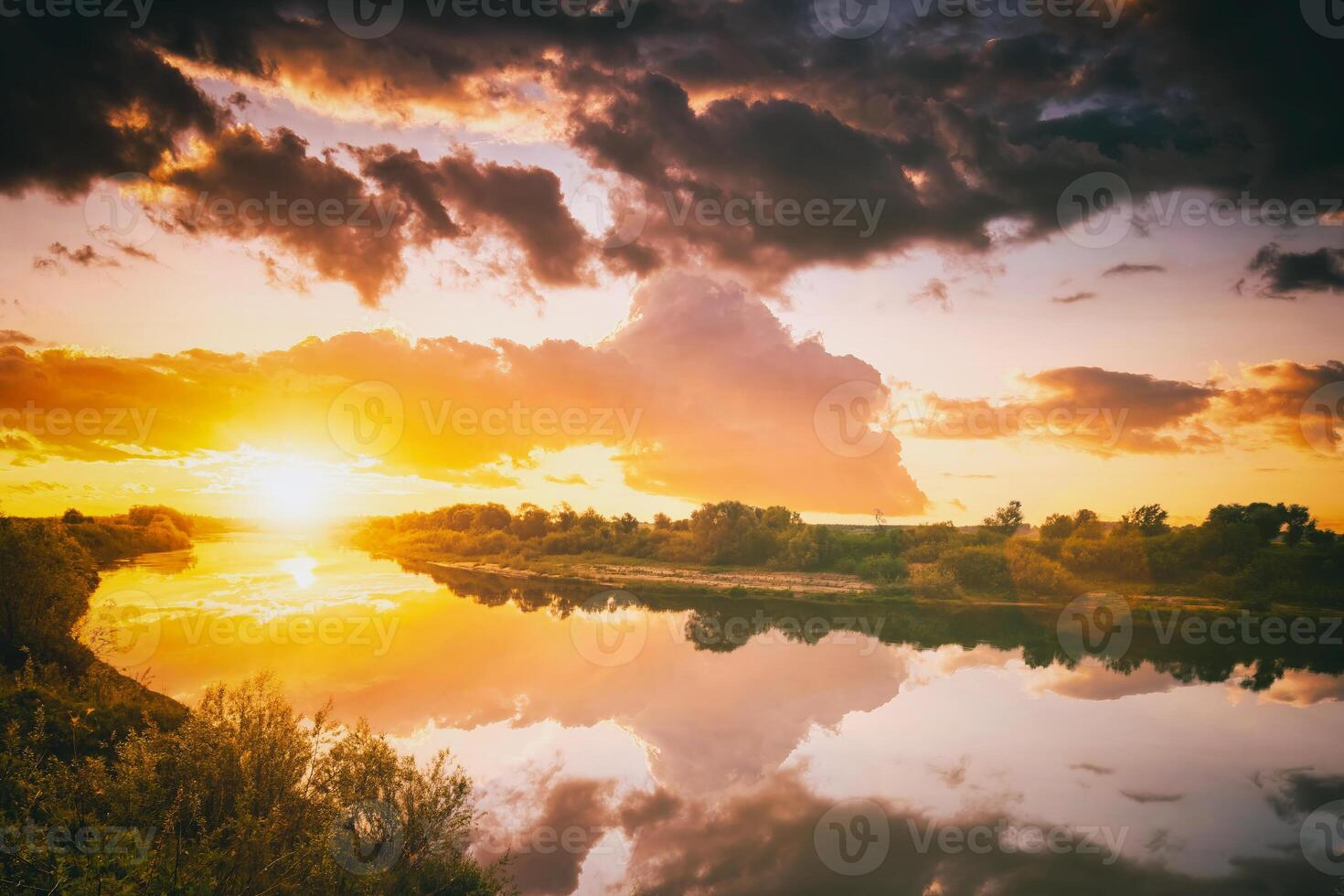 Sunrise or sunset on a lake or river with cloudy sky reflection in the water in summertime. Aesthetics of vintage film. photo
