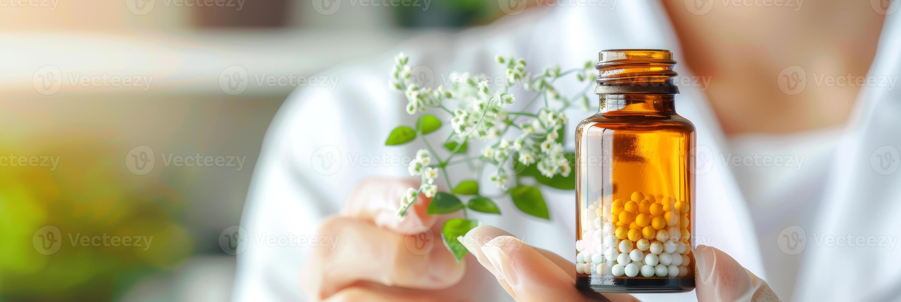 Bottle of homeopathic pellets held by professional homeopath, set against modern background of clinic. Concept of homeopathy, alternative medicine, organic apothecary, naturopathy. Banner. Copy space. photo