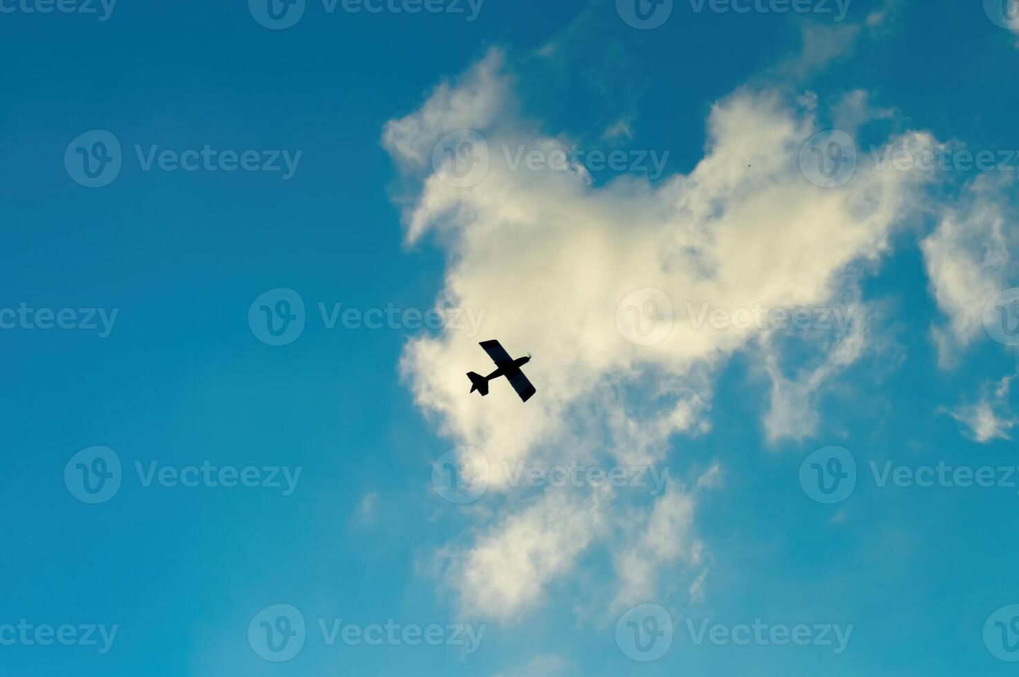 a remote control aeromodelling airplane on a cloudy blue sky background. perfect for background, texture, and aviation content photo