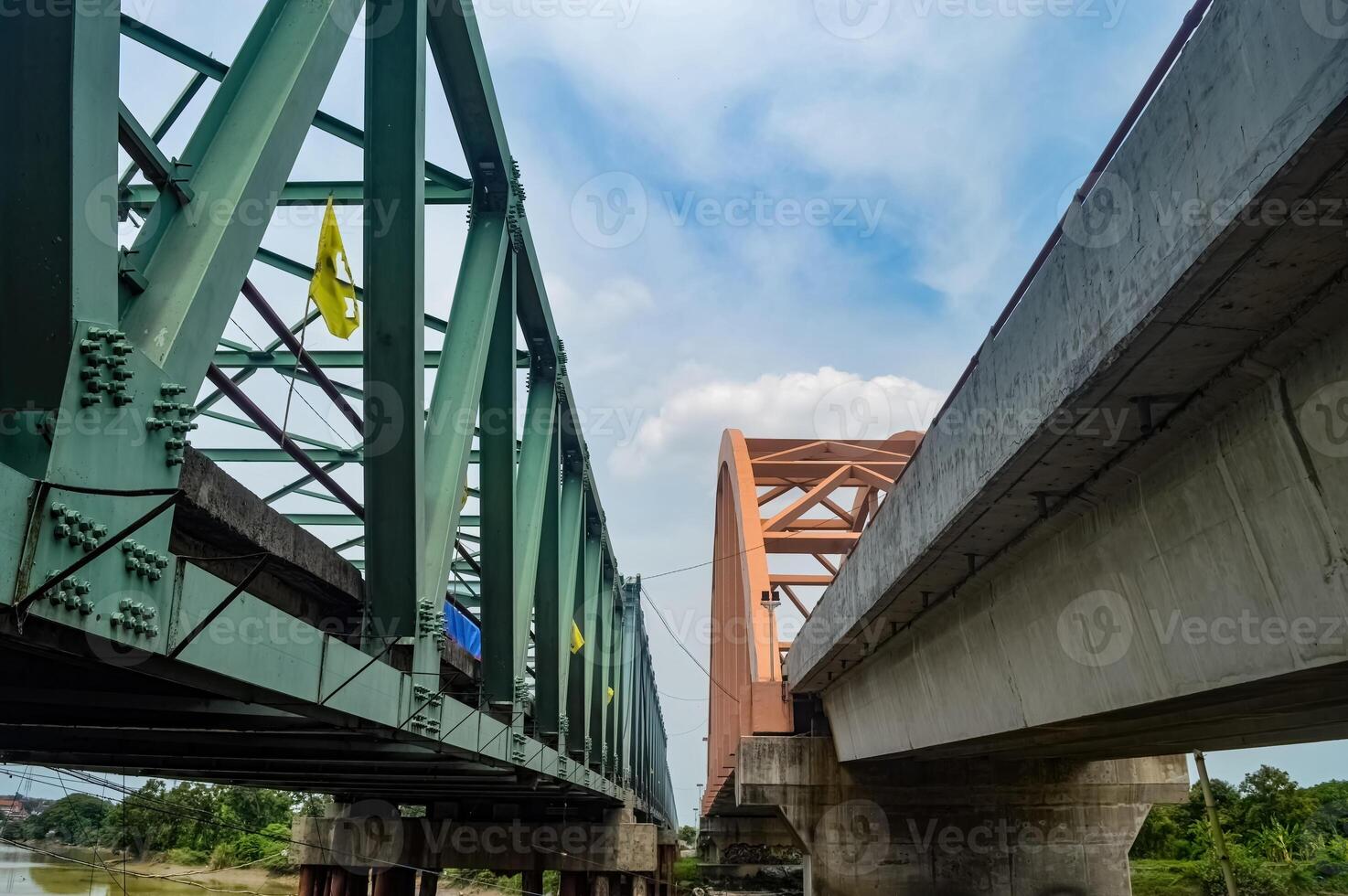 two large bridges, steel truss bridge and arch bridge, cross the river. Low Angle photo