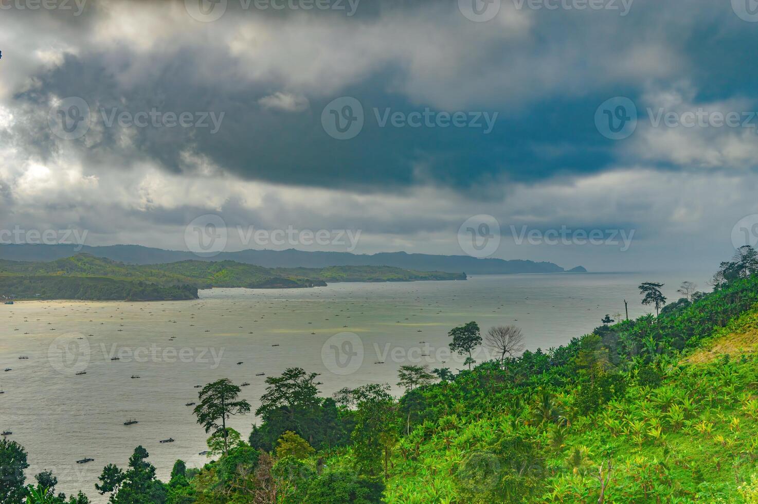 natural scenery of gemah beach and popoh bay facing the south sea of java island or indian ocean decorated with some mountains photo