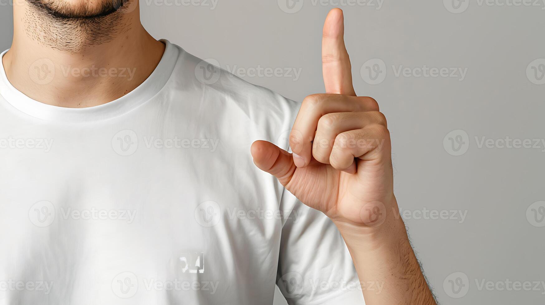 A man in a t-shirt shows a finger in the screen. photo