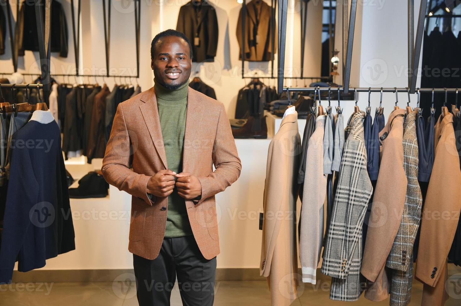 A handsome young african gentleman buying an elegant suit photo