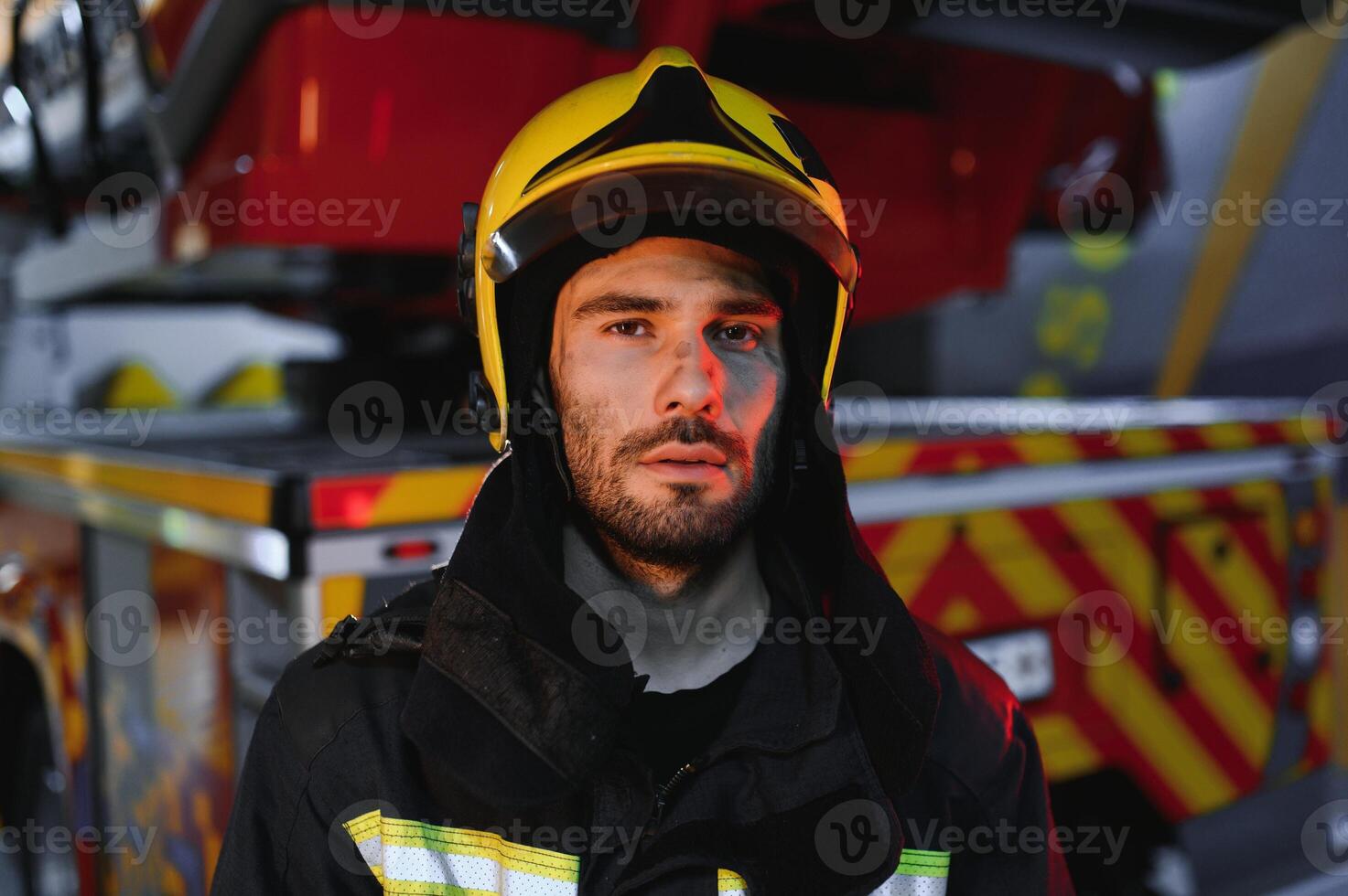 Photo of fireman with gas mask and helmet near fire engine