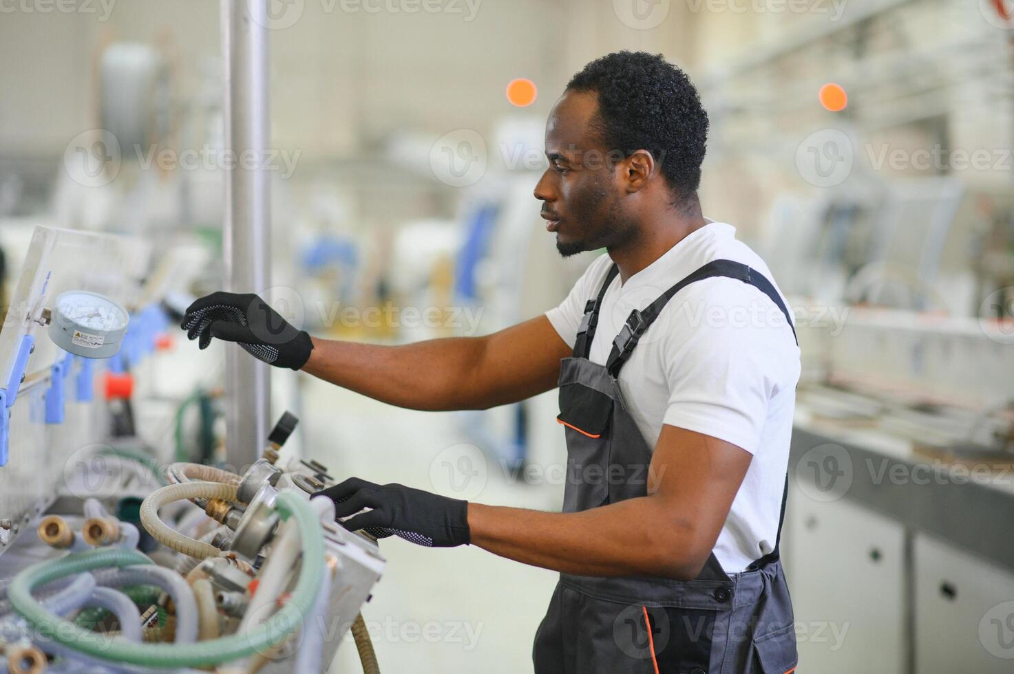 Factory for aluminum and PVC windows and doors production. Manual worker assembling PVC windows and doors photo