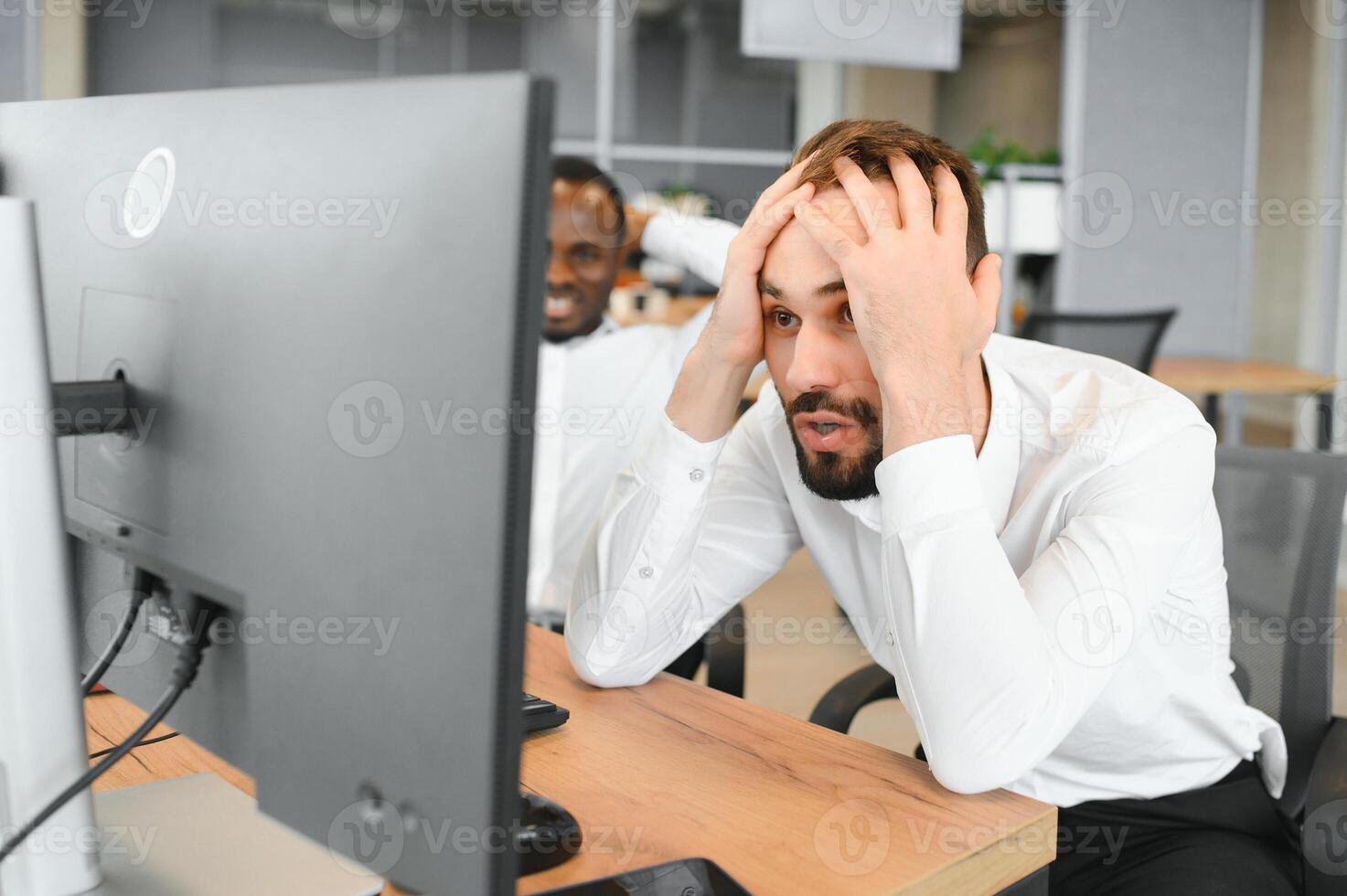 Two Unhappy tired businessman, corporate manager, sits at the workplace, tired from online work, stressed, nervous, massages the bridge of his nose, closed his eyes, experiencing a headache photo