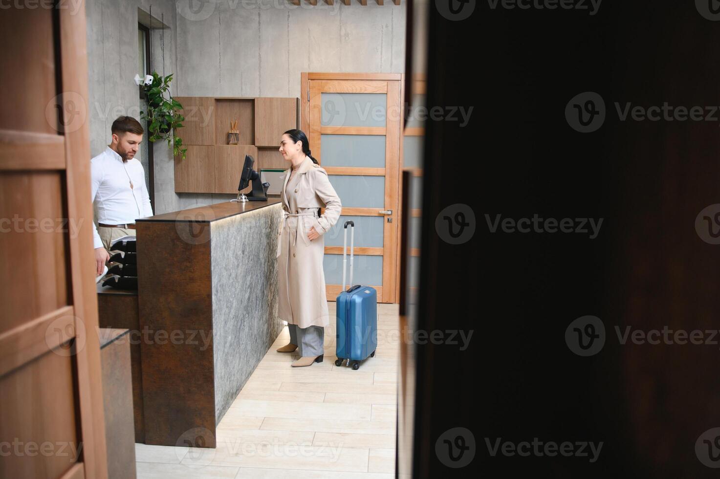 Picture of guests getting key card in hotel photo