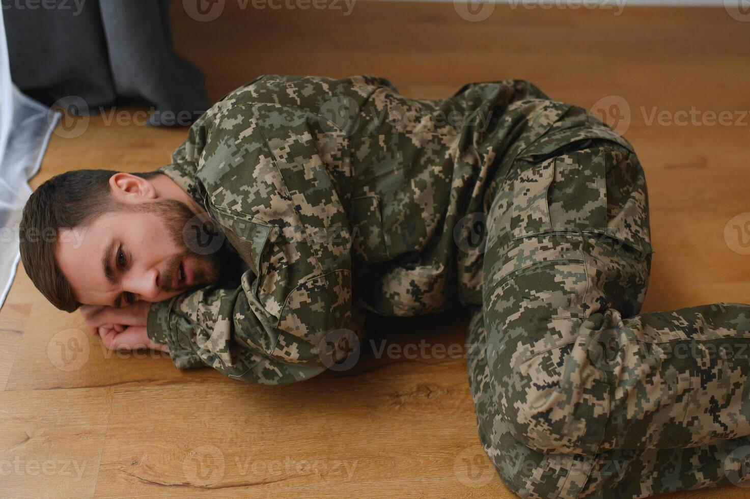 Depressed man recalling war days. Portrait of veteran soldier who has PTSD photo