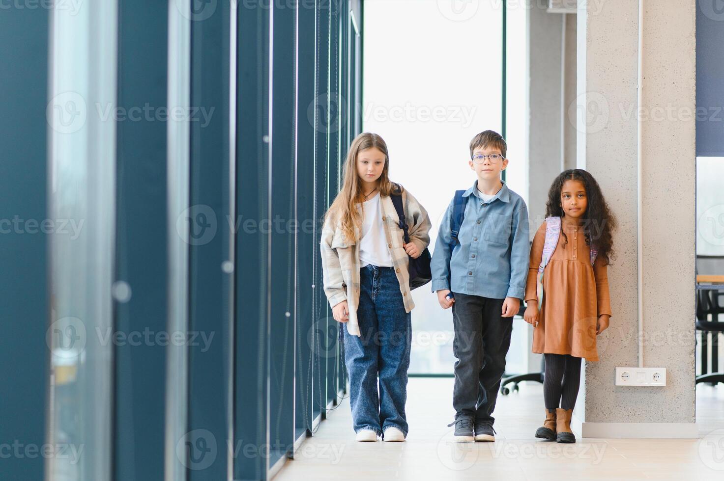 Group of elementary school kids in a school corridor photo