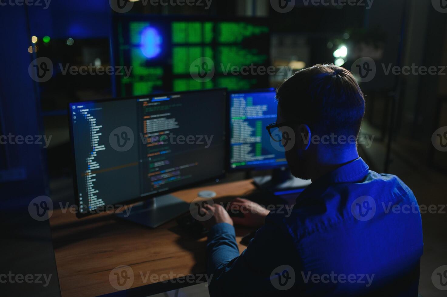 Night Office Young Handsome Man in Working on Desktop Computer. Digital Entrepreneur Typing Code photo
