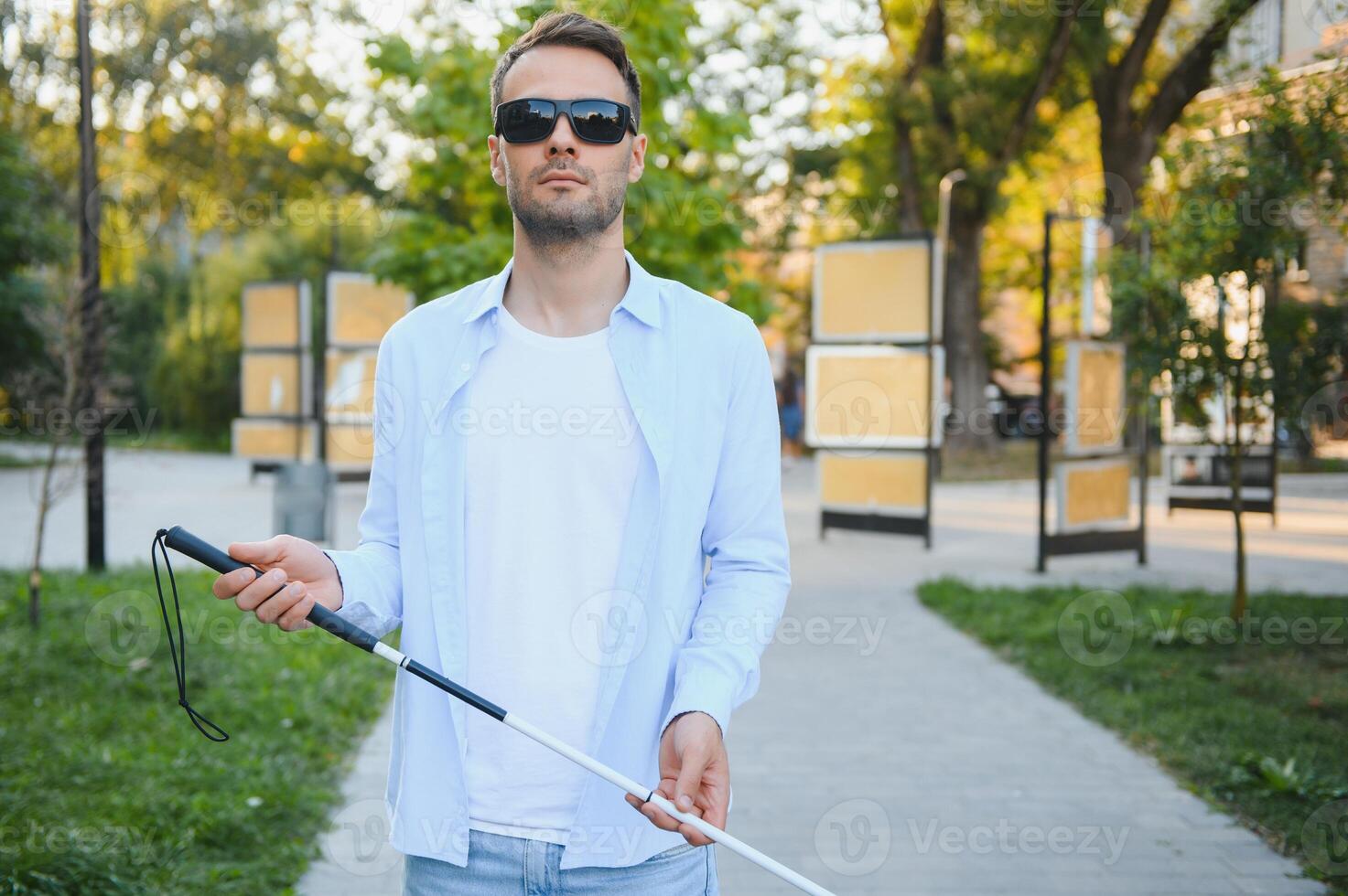 Blind man. Visually impaired man with walking stick, photo